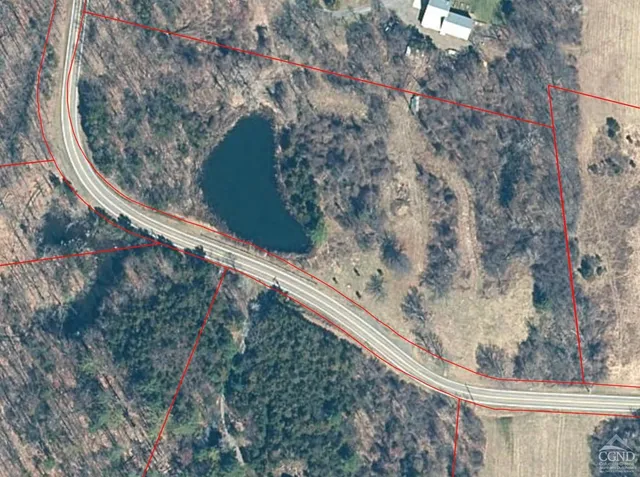a view of a yard with wooden fence