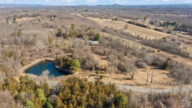 an aerial view of house with yard and mountain view