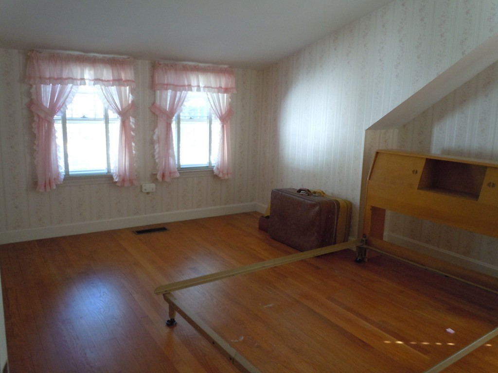 57 Grandview Street Springfield, MA 01118 - Photo 12 of 16 an empty room with wooden floor and windows