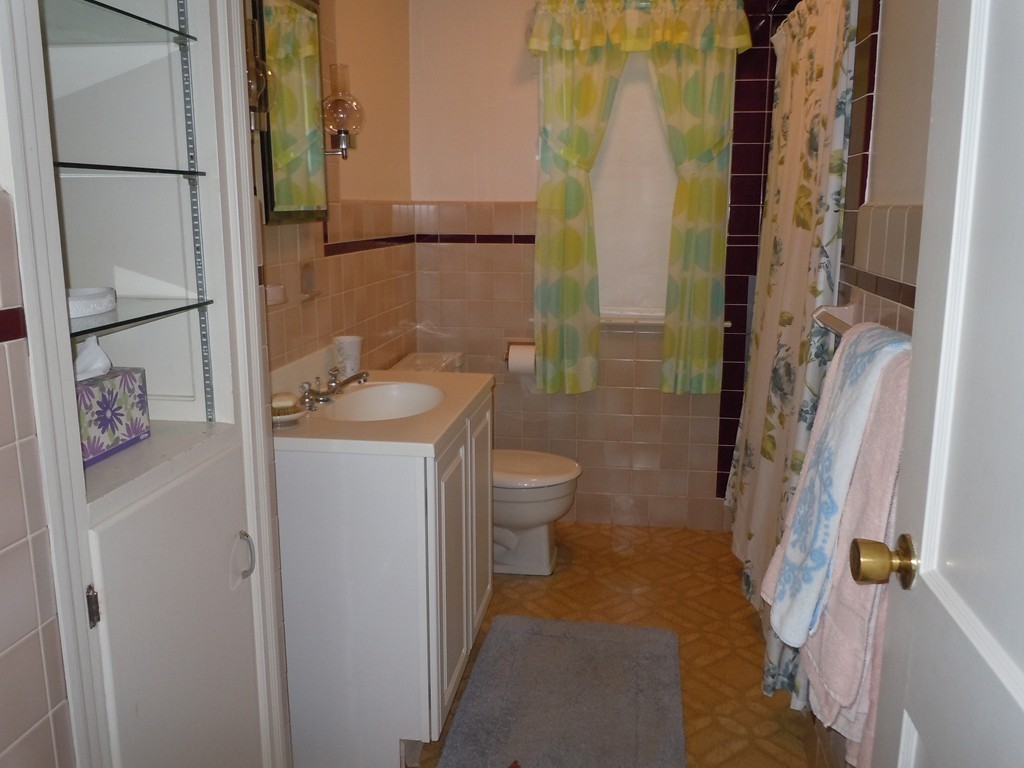 57 Grandview Street Springfield, MA 01118 - Photo 5 of 16 a bathroom with a granite countertop sink toilet and shower
