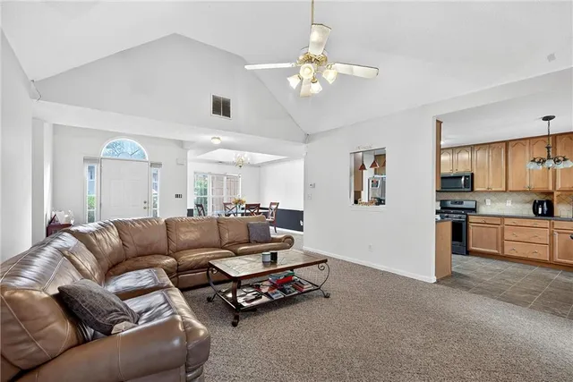 a living room with furniture and a kitchen