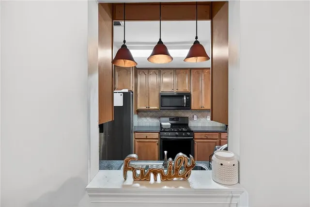 a kitchen with a sink cabinets and appliances
