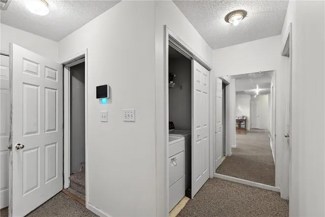 a view of a hallway with closet and wooden floor