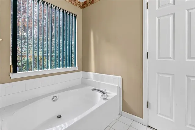 a white bath tub sitting next to a window