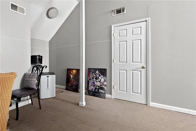 a view of a livingroom with furniture and a window