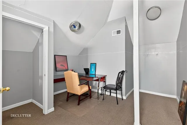 a workspace room with furniture and a window