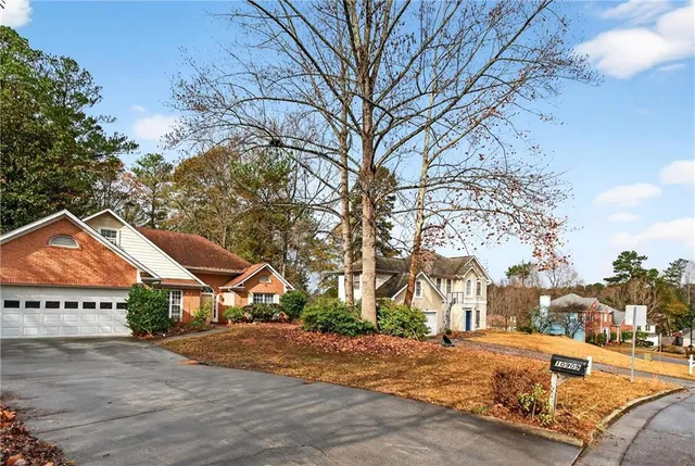 a view of a house with snow on the side of the road