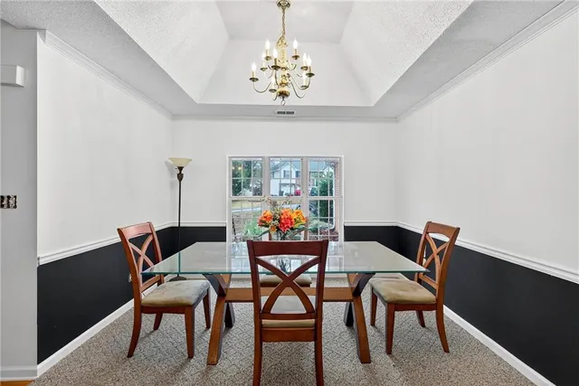 a view of a dining room with furniture wooden floor and chandelier