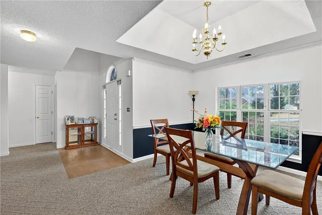 a view of a dining room with furniture window and outside view