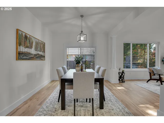 a dining room with furniture a chandelier and wooden floor