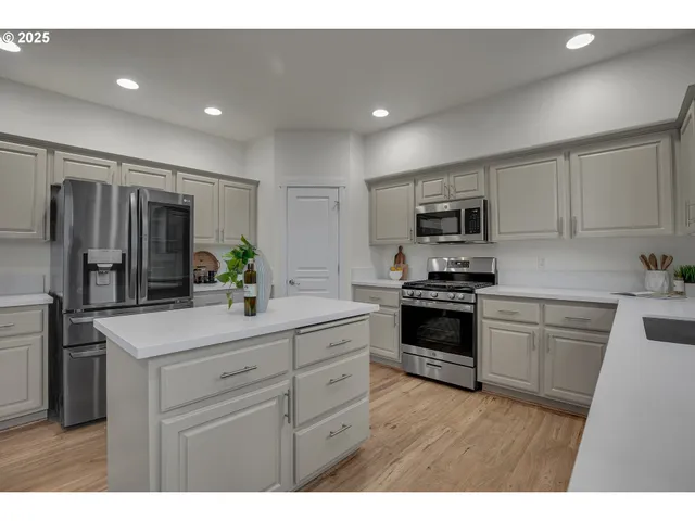 a kitchen with a sink stove and refrigerator