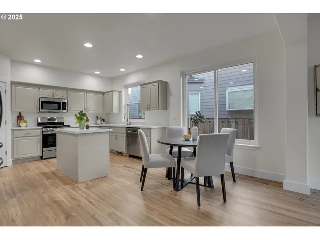 a open kitchen with cabinets table and chairs