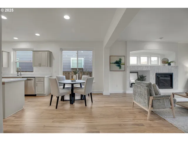 a dining room with furniture and wooden floor