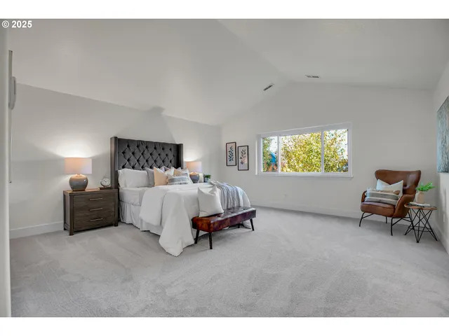 a spacious bedroom with a bed and a couch