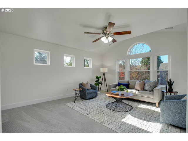 a living room with furniture a chandelier and a window