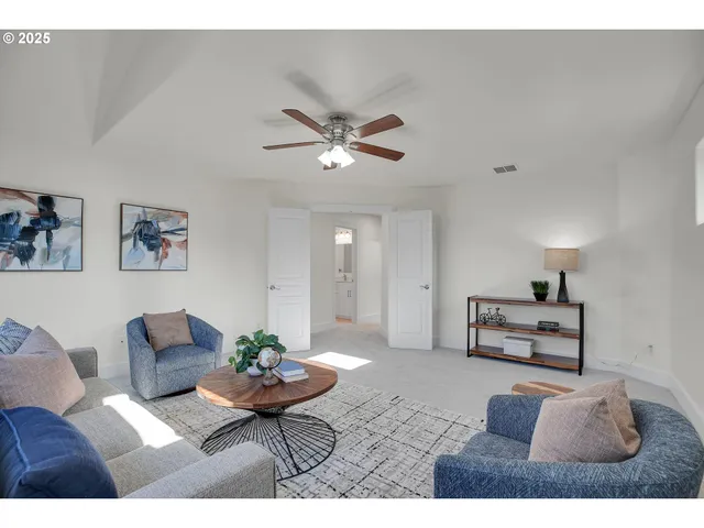 a living room with furniture and flowers