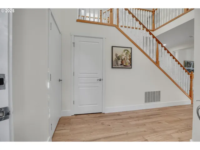 a view of an entryway with wooden floor
