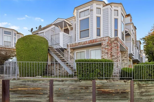 a view of a brick building next to a yard