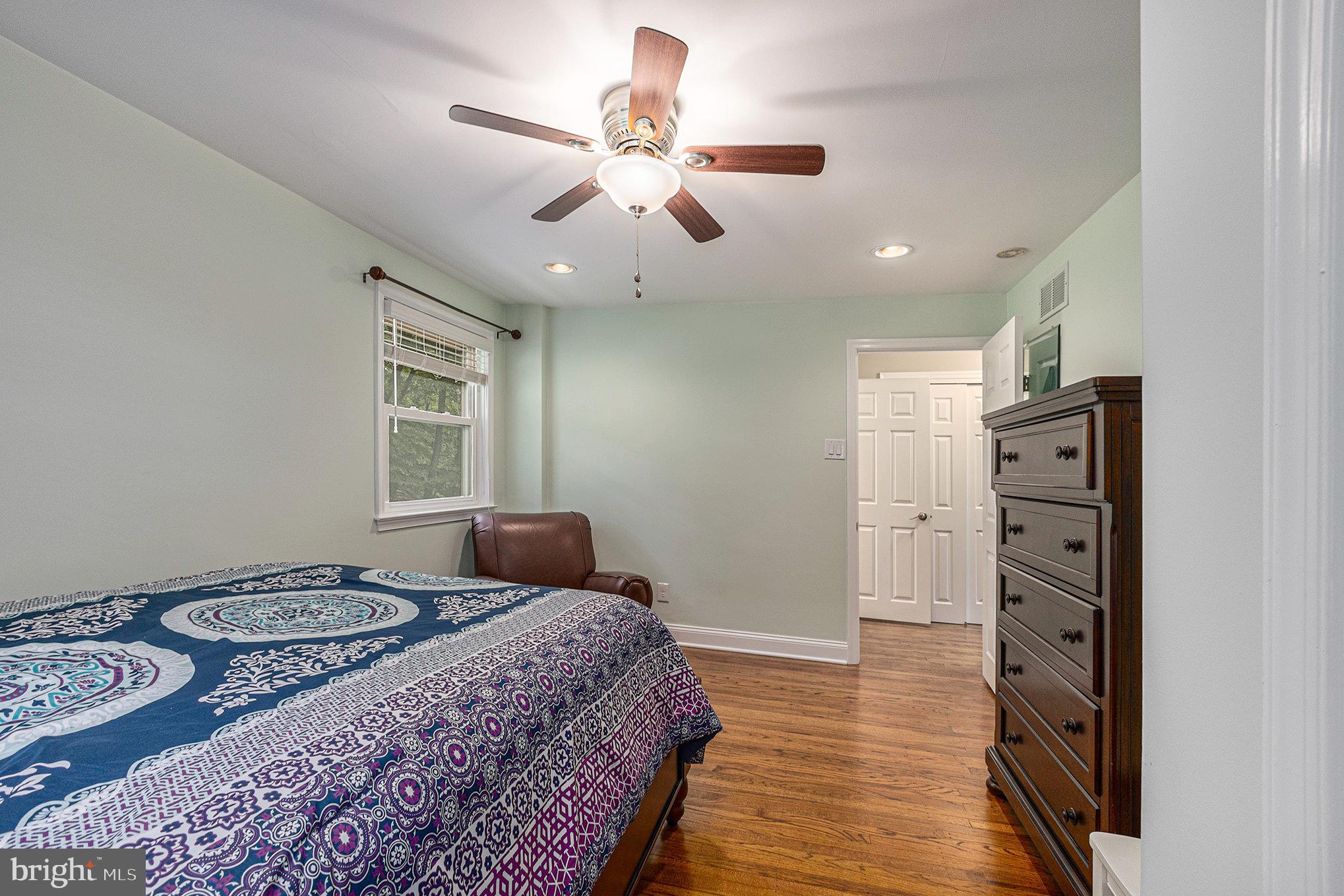 556 Forest Road Wayne, PA 19087 - Photo 12 of 35 a bedroom with a bed and a chandelier