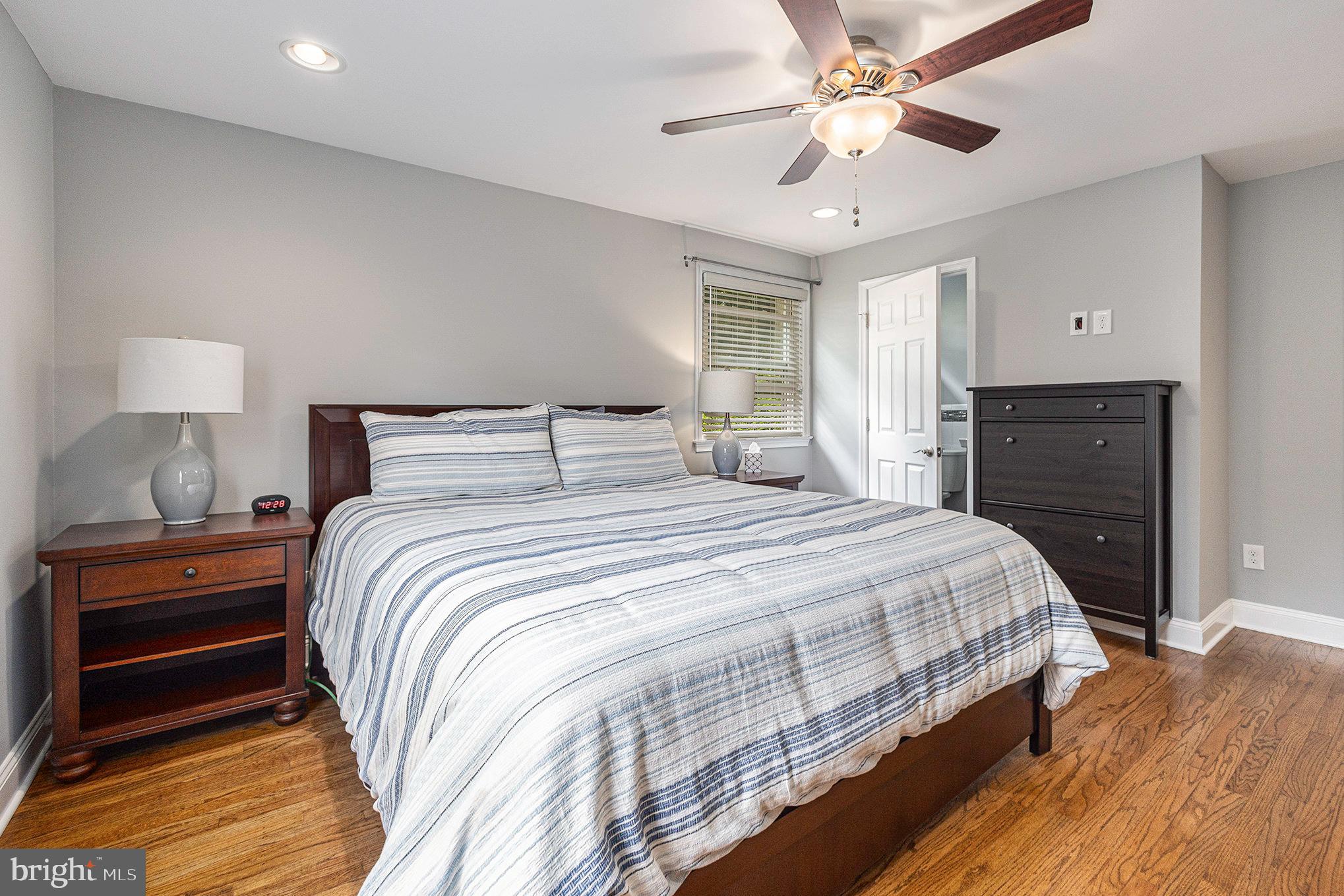 556 Forest Road Wayne, PA 19087 - Photo 16 of 35 a bedroom with a bed and a chandelier