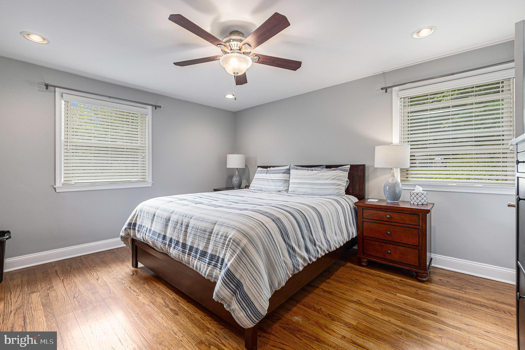 556 Forest Road Wayne, PA 19087 - Photo 17 of 35 a bedroom with a large bed chandelier and a window