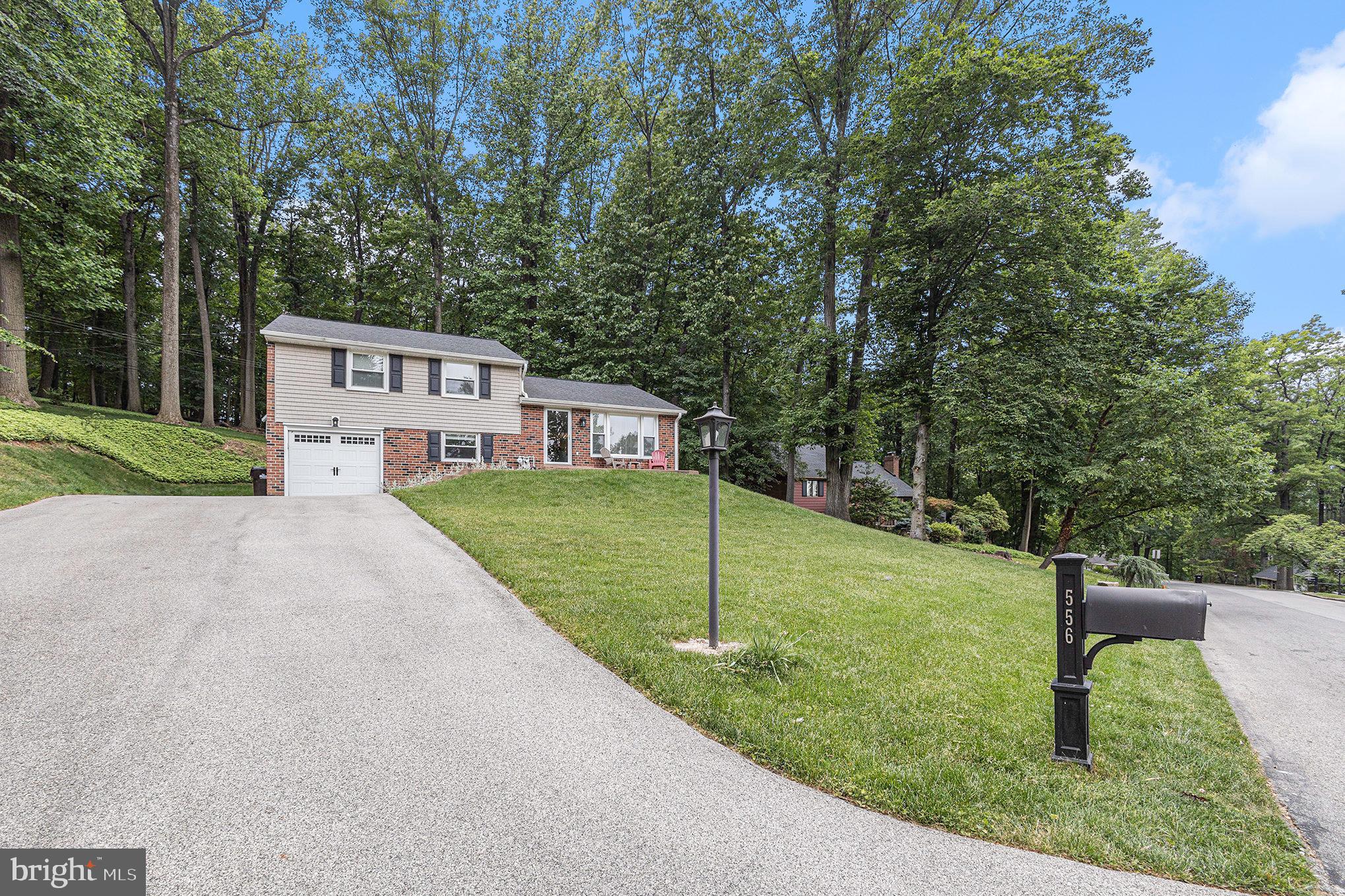 556 Forest Road Wayne, PA 19087 - Photo 2 of 35 a view of a house with backyard and garden