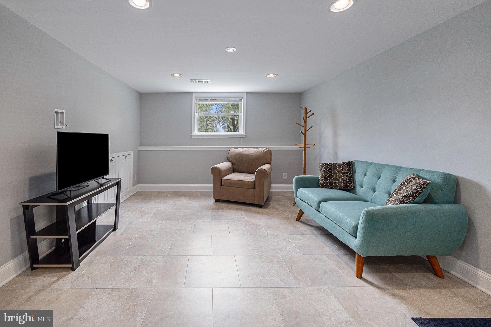 556 Forest Road Wayne, PA 19087 - Photo 21 of 35 a living room with furniture and a flat screen tv