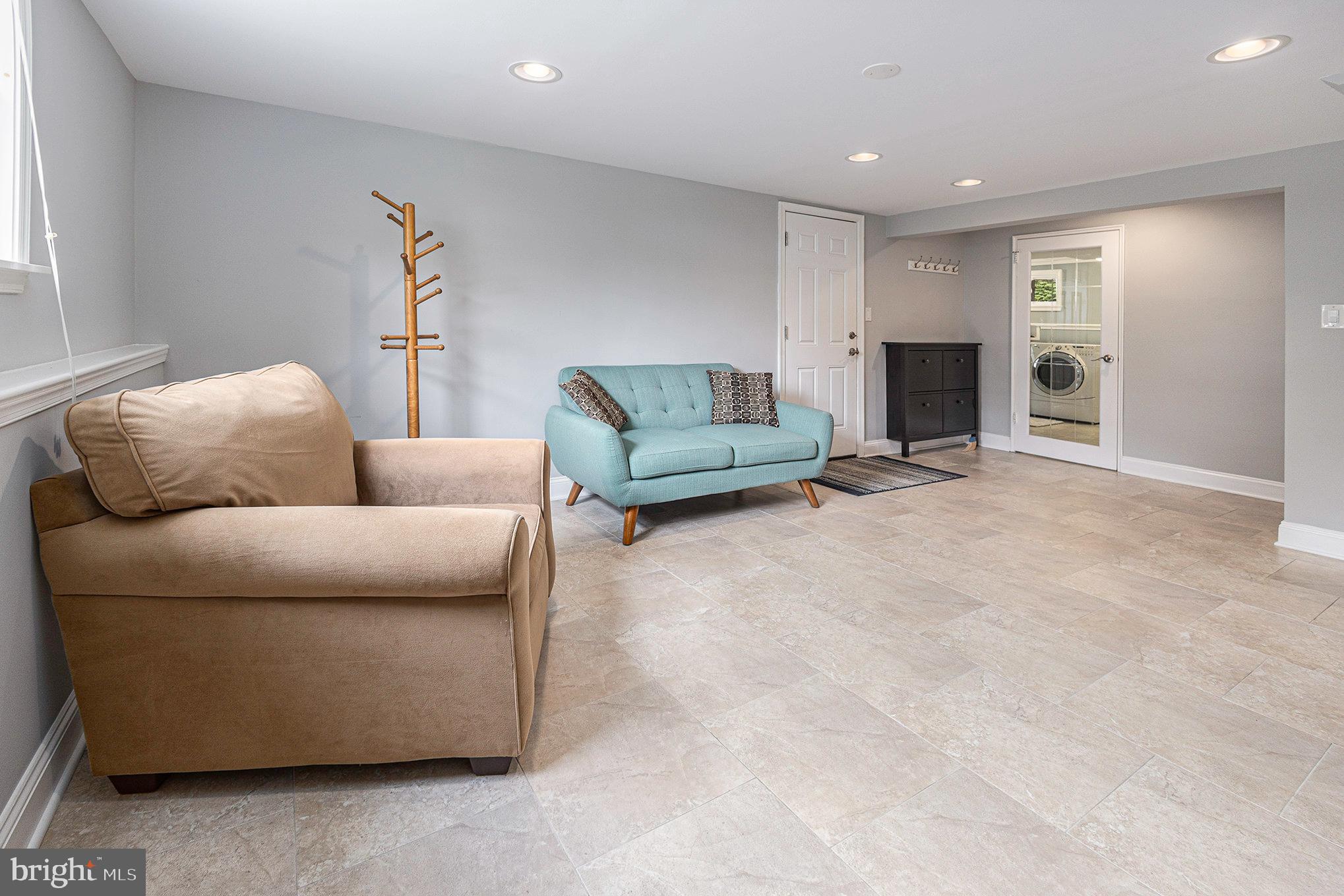 556 Forest Road Wayne, PA 19087 - Photo 23 of 35 a living room with furniture and a fireplace