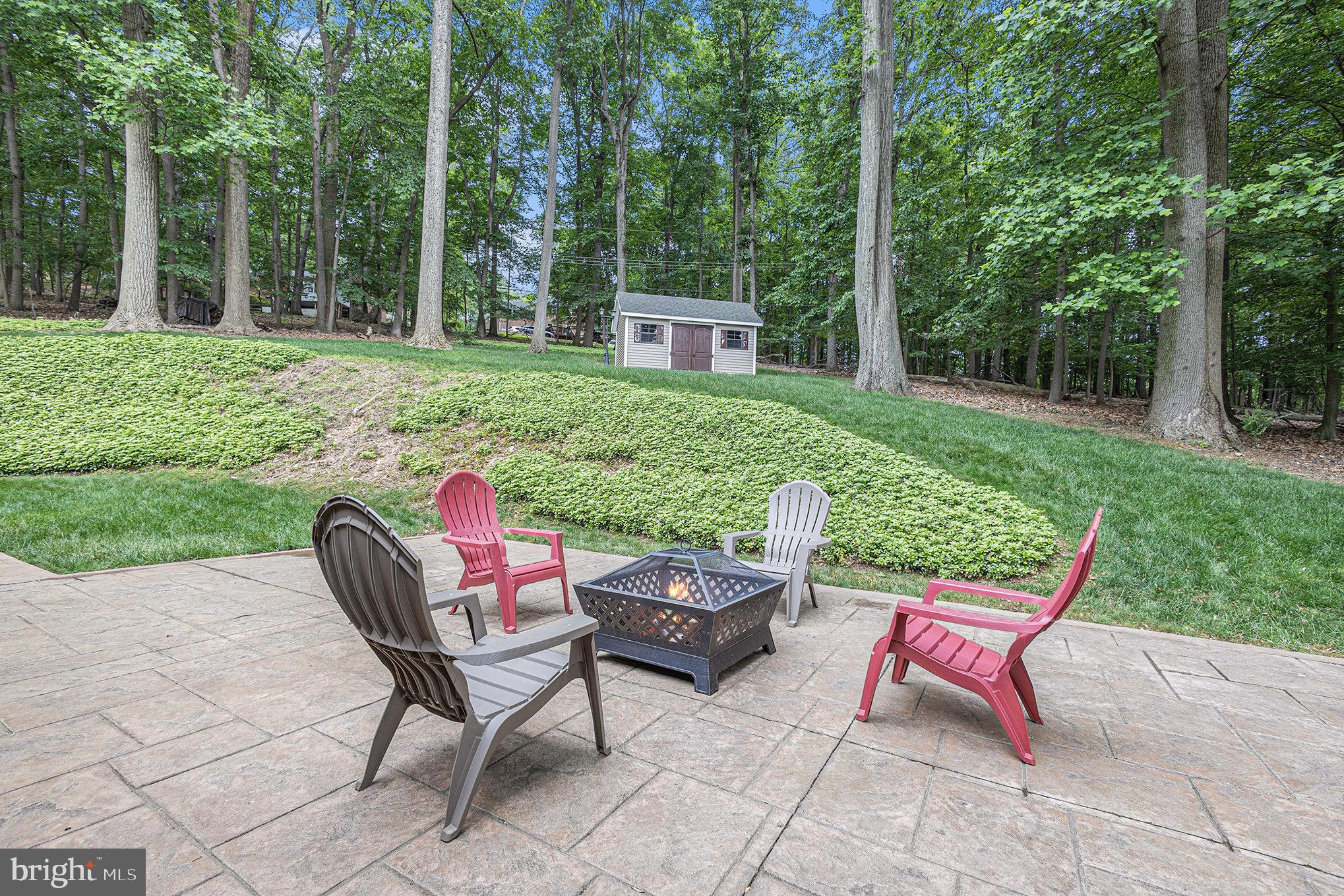 556 Forest Road Wayne, PA 19087 - Photo 28 of 35 a view of a chairs and backyard with large trees