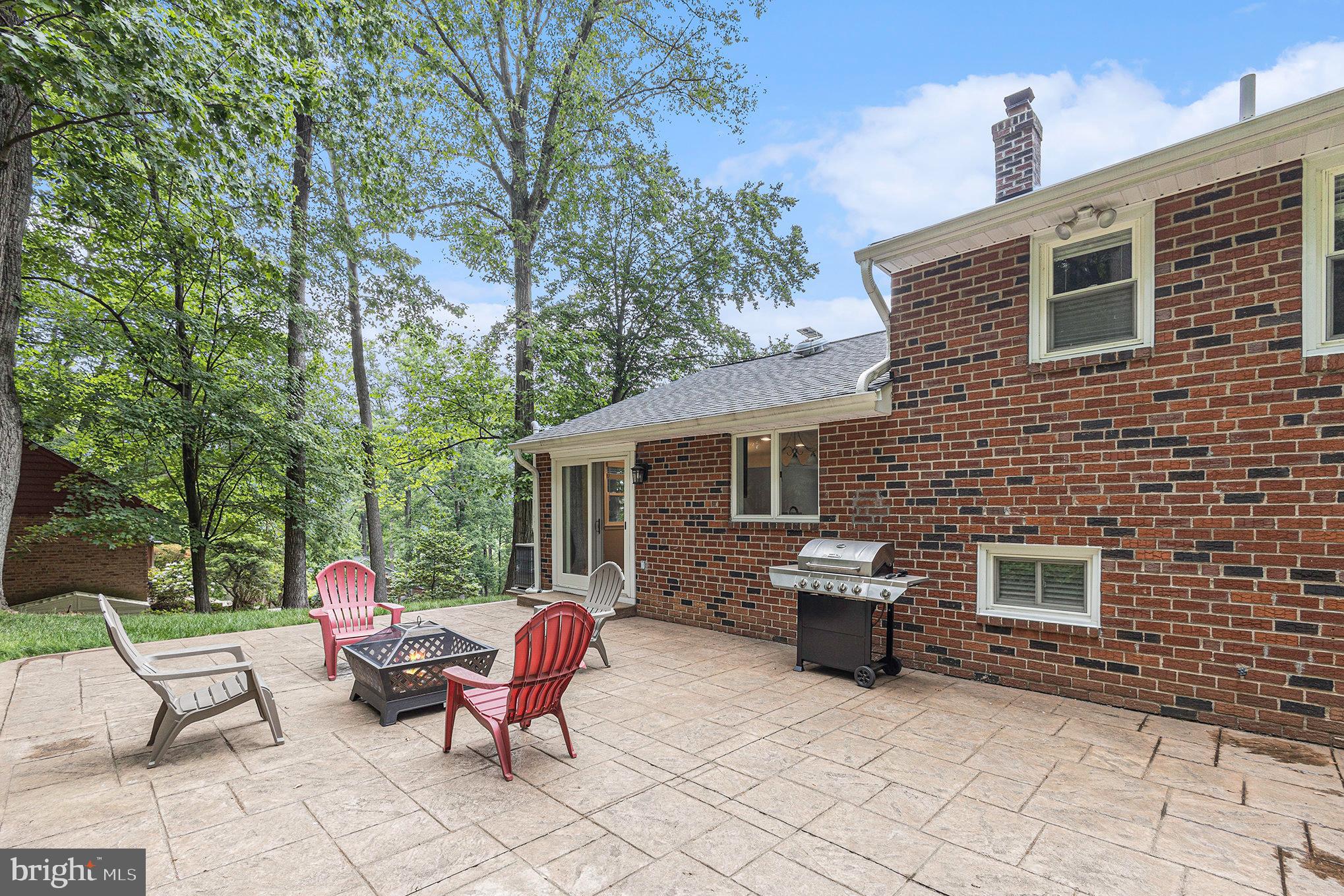 556 Forest Road Wayne, PA 19087 - Photo 30 of 35 a backyard of a house with fire pit and outdoor seating