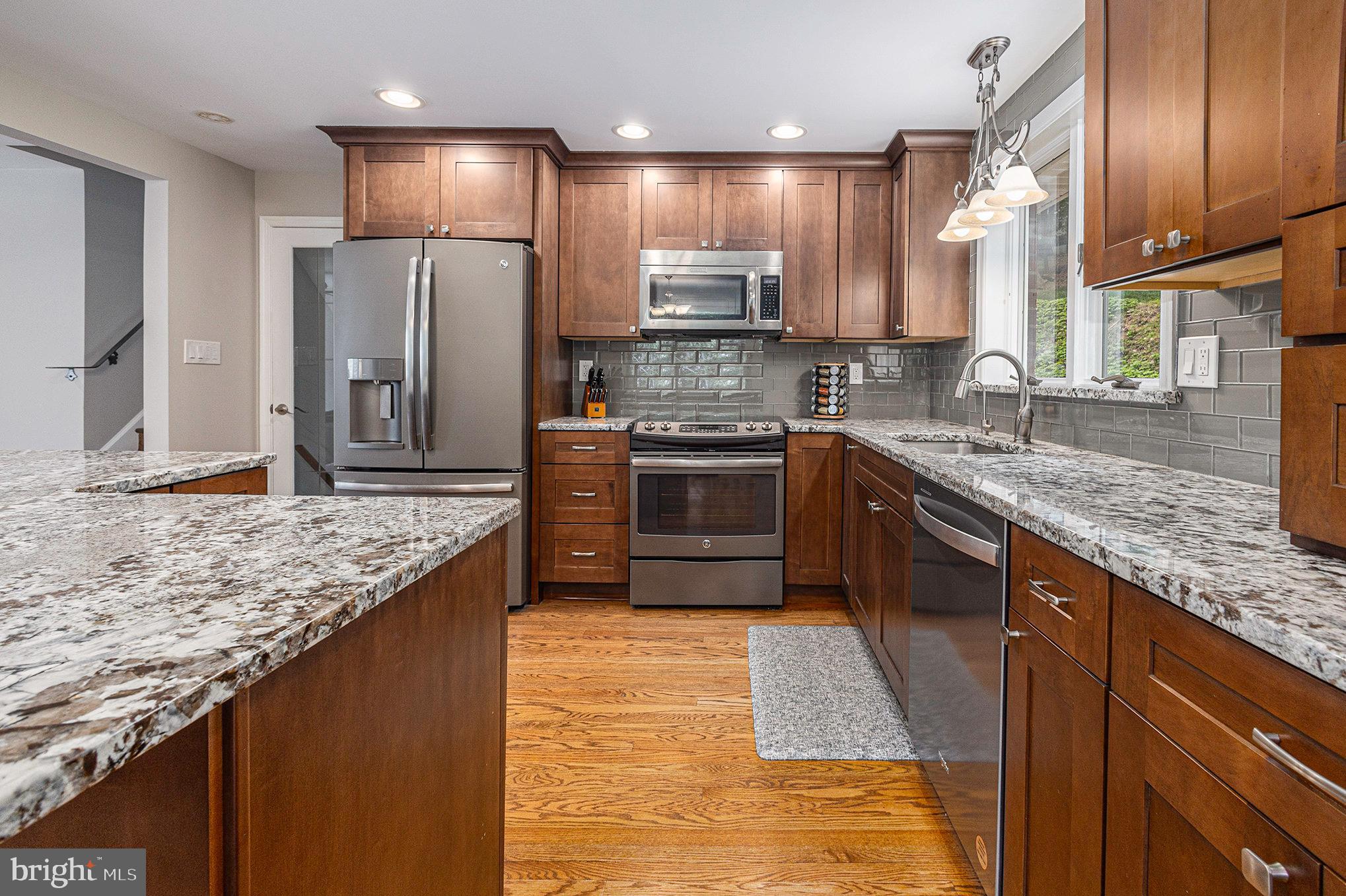 556 Forest Road Wayne, PA 19087 - Photo 8 of 35 a kitchen with stainless steel appliances granite countertop a sink stove and refrigerator