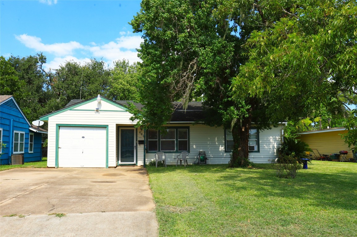 405 Center Way Lake Jackson, TX 77566 - Photo 1 of 21 a front view of a house with a garden