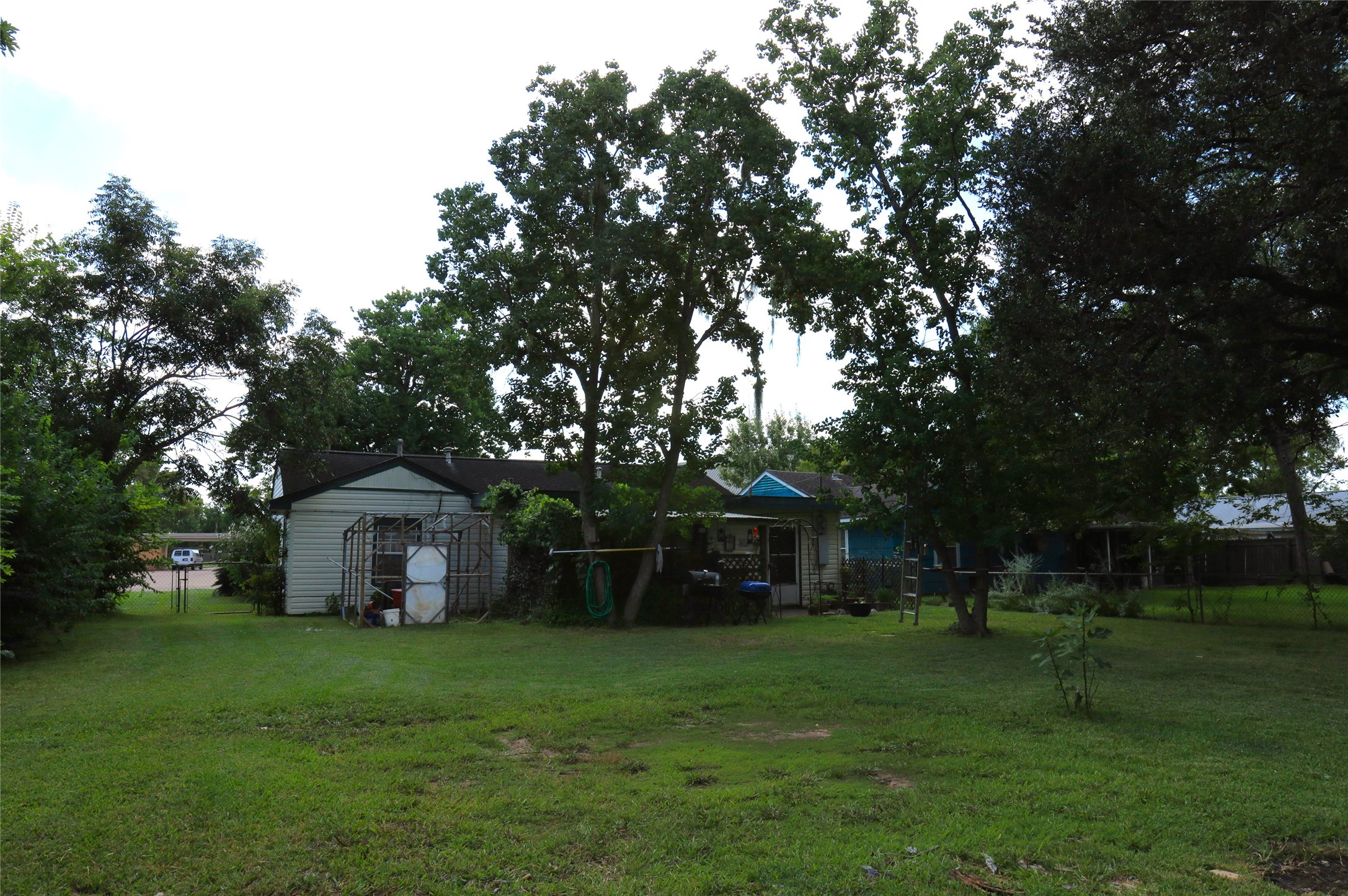 405 Center Way Lake Jackson, TX 77566 - Photo 18 of 21 a front view of a house with a garden and trees