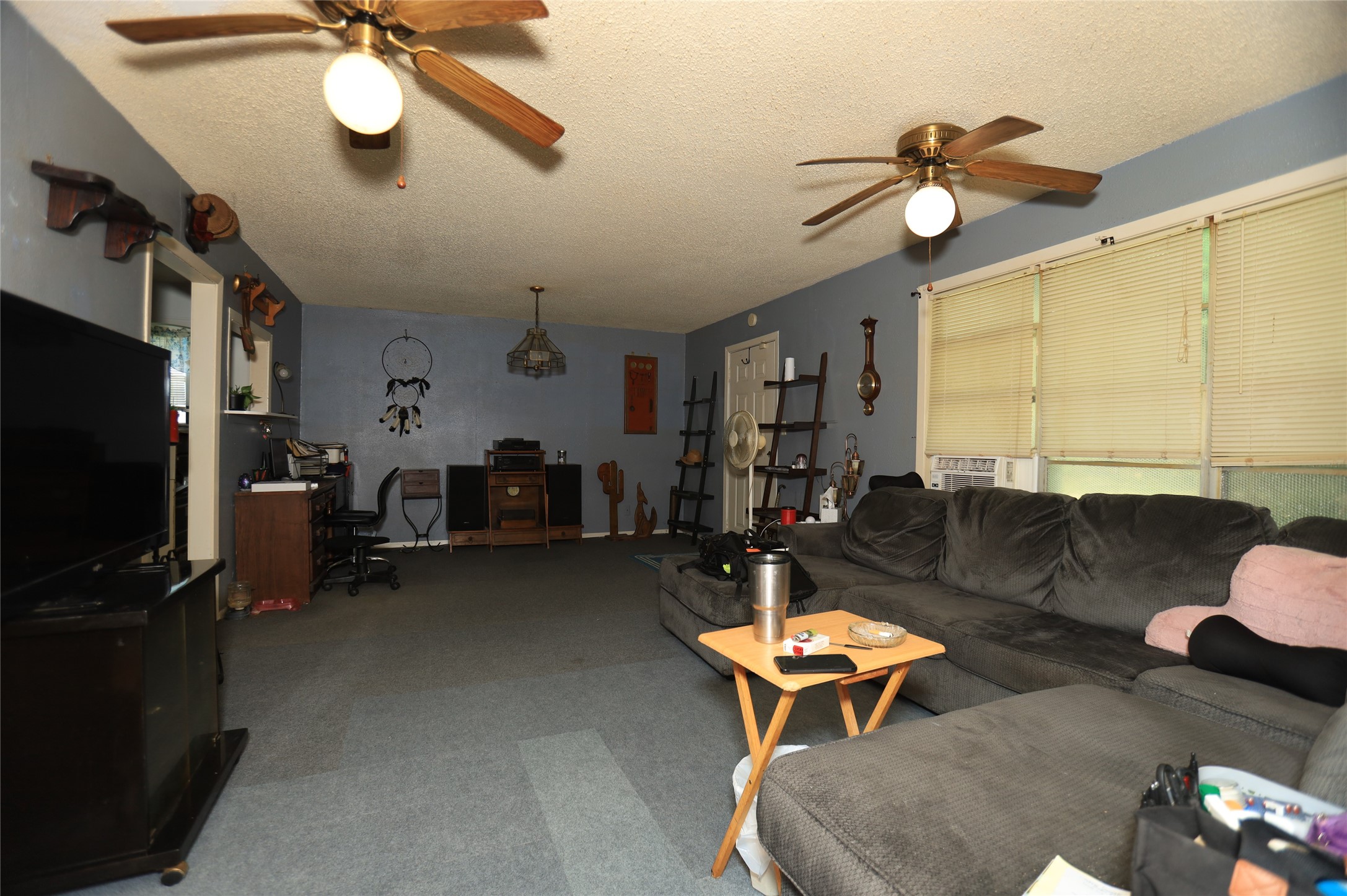 405 Center Way Lake Jackson, TX 77566 - Photo 10 of 21 a living room with furniture a chandelier and a flat screen tv