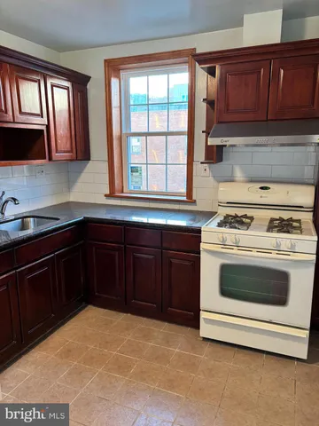 a kitchen with a stove and a sink