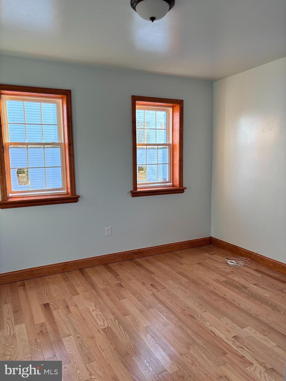 1320 West Girard Avenue Philadelphia, PA 19123 - Photo 5 of 5 an empty room with wooden floor and windows