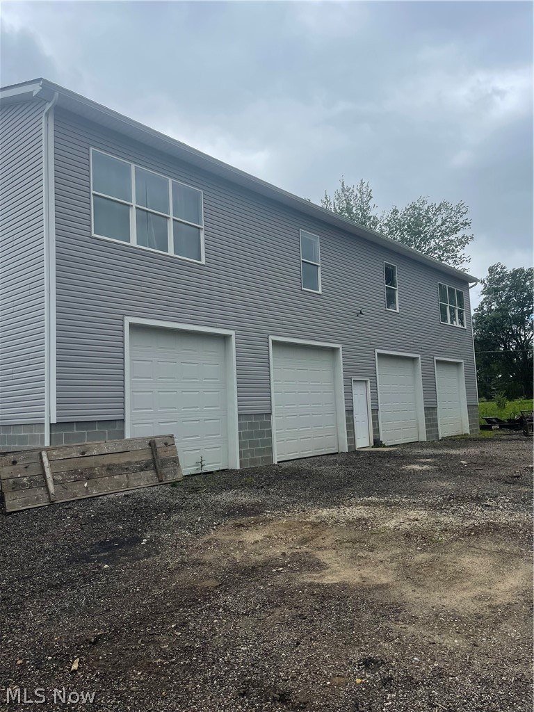 1627 Krumroy Road Akron, OH 44306 - Photo 2 of 11 View of side of home featuring a garage. Under Construction 2024
