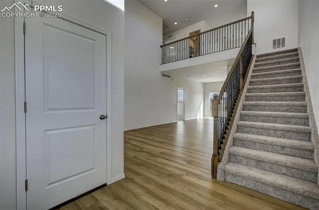 a view of entryway and hall with wooden floor