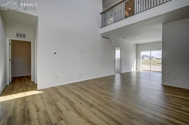 a view of a room with wooden floor