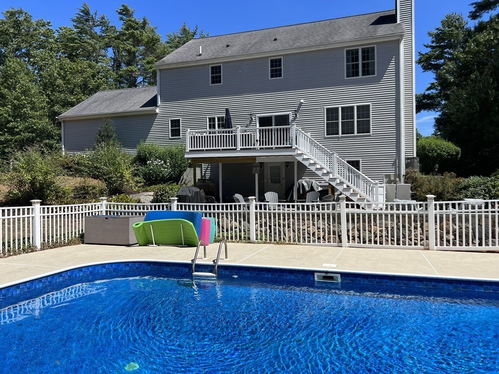 a view of a house with wooden deck and a yard