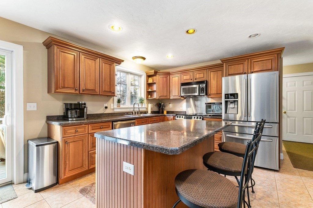47 Mayflower Lane Rochester, MA 02770 - Photo 12 of 40 a kitchen with kitchen island a large counter top space appliances and a window