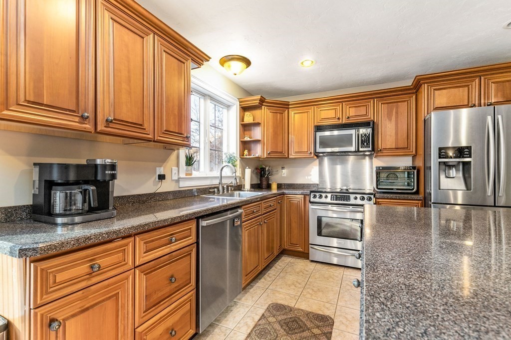 47 Mayflower Lane Rochester, MA 02770 - Photo 13 of 40 a kitchen with stainless steel appliances granite countertop a stove a sink and a microwave