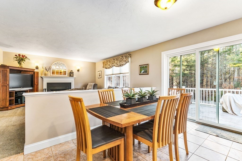 47 Mayflower Lane Rochester, MA 02770 - Photo 15 of 40 a view of a dining room with furniture a fireplace and wooden floor