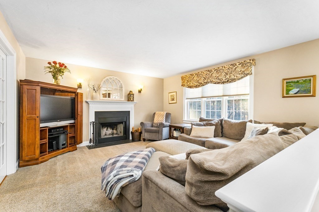 47 Mayflower Lane Rochester, MA 02770 - Photo 23 of 40 a living room with furniture large window and a fireplace