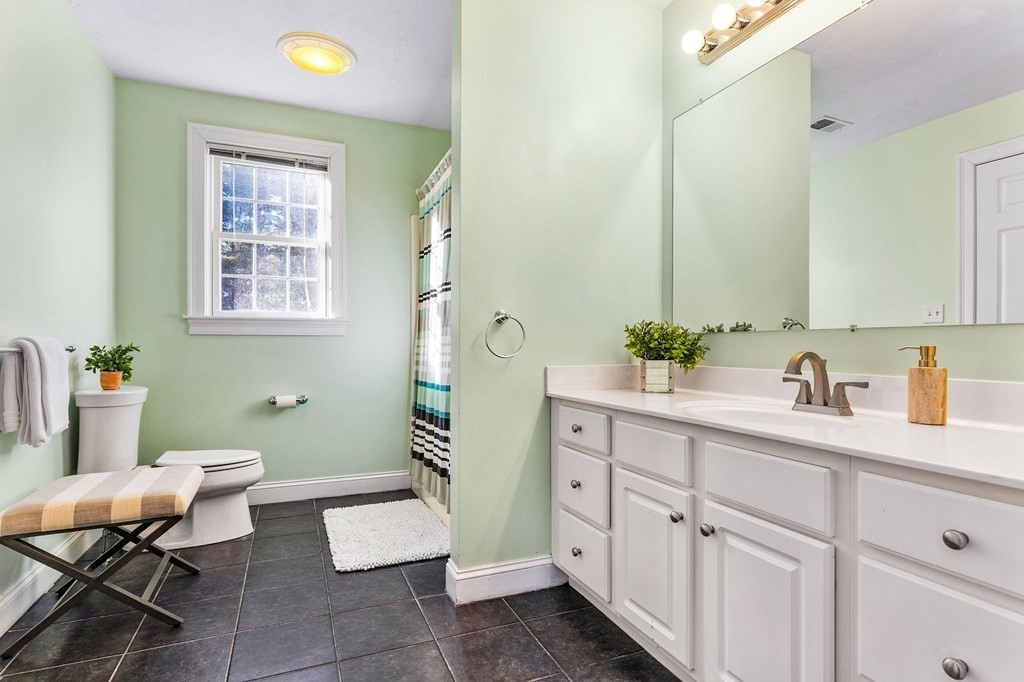 47 Mayflower Lane Rochester, MA 02770 - Photo 29 of 40 a spacious bathroom with a granite countertop sink a toilet and a mirror