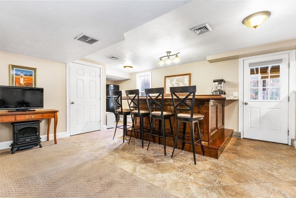 47 Mayflower Lane Rochester, MA 02770 - Photo 32 of 40 a view of a livingroom with furniture and a flat screen tv
