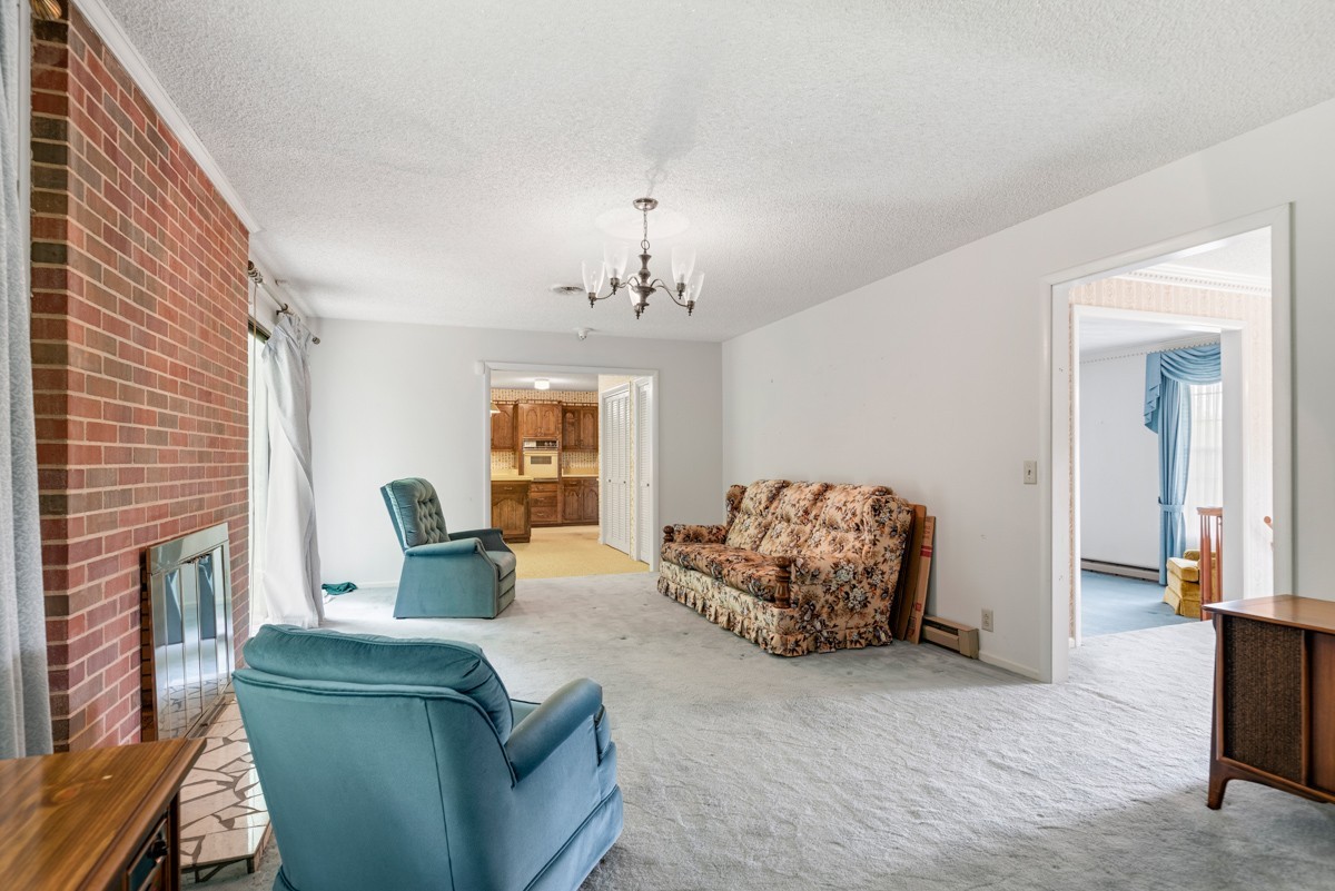 6908 River Rd Pike Nashville, TN 37209 - Photo 15 of 47 a living room with furniture and a chandelier