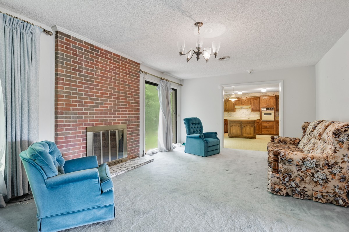 6908 River Rd Pike Nashville, TN 37209 - Photo 16 of 47 a living room with furniture and a fireplace