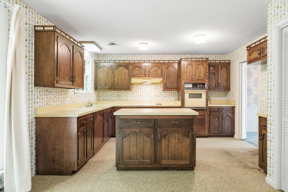 6908 River Rd Pike Nashville, TN 37209 - Photo 19 of 47 a kitchen with stainless steel appliances granite countertop a sink stove and refrigerator