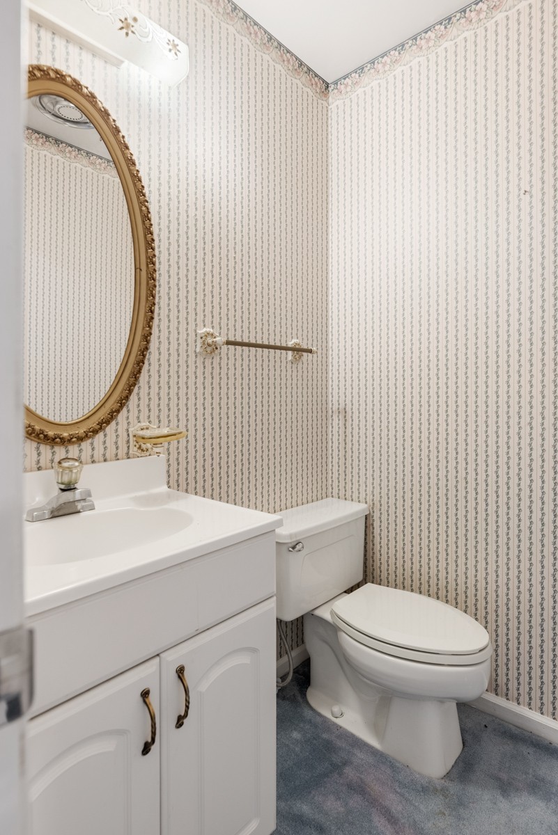 6908 River Rd Pike Nashville, TN 37209 - Photo 29 of 47 a white toilet sitting next to a bathroom sink